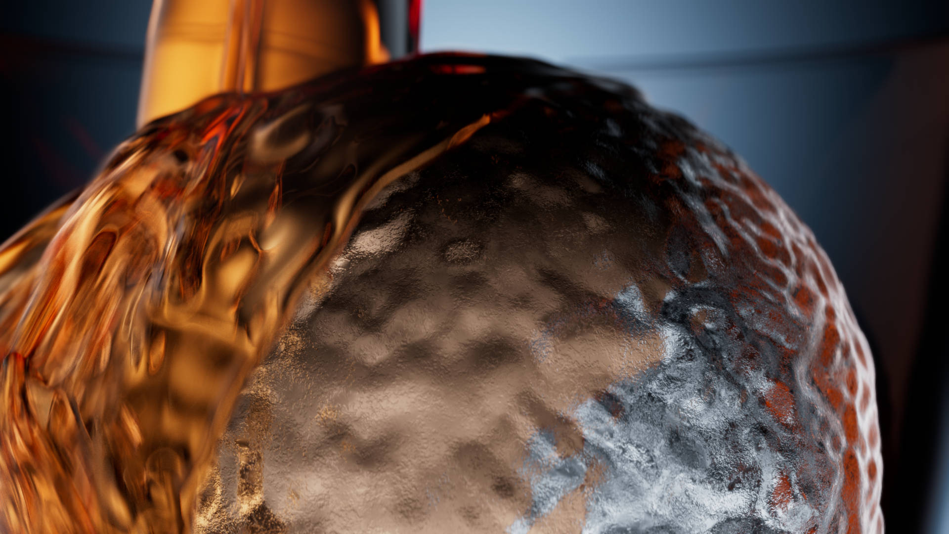 Close-up of whisky pouring on ice ball in slow motion.