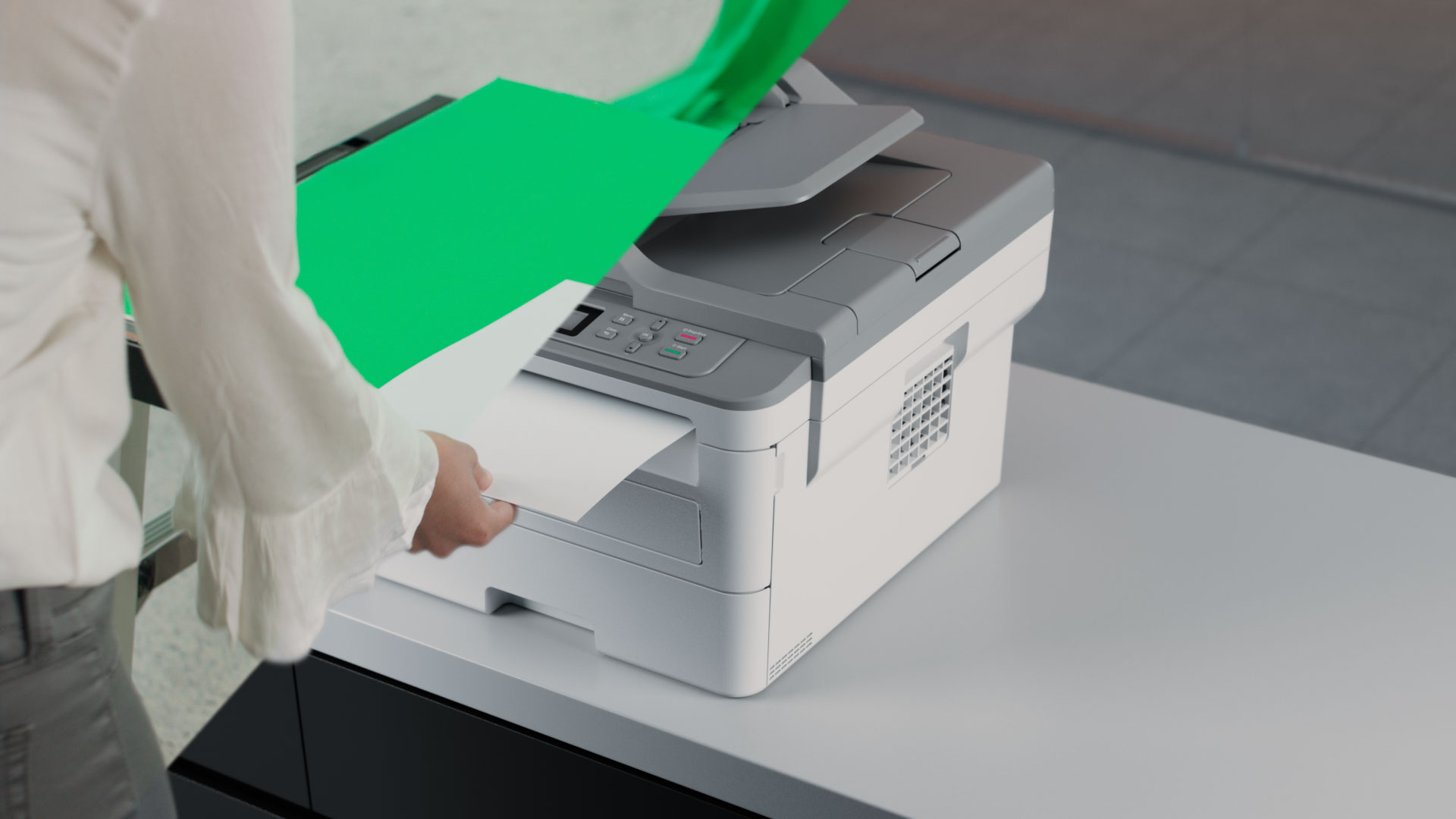 Split view composite of live footage of a person interacting with a CG printer.